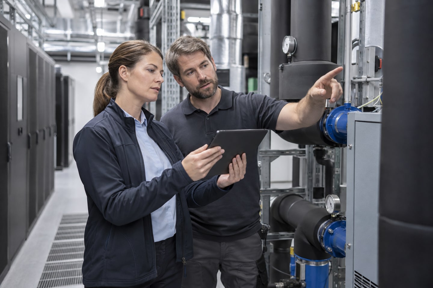 Techniker prüfen die Kühlungsinfrastruktur eines Rechenzentrums Techniker prüfen die Kühlungsinfrastruktur eines Rechenzentrums